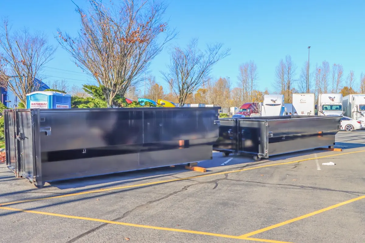 Professional dumpster rental service with roll-off container on residential driveway in Reedurban